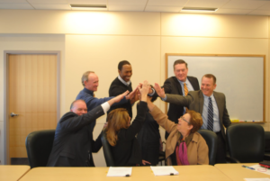 Lt. Gov Karyn Polito, Craig Blais, Kevin O'Sullivan, Travis McCready, Ed Augusus, Tim Murray all high-five after signing the paperwork for the expansion/inclusion of the Reactory to the biotech park